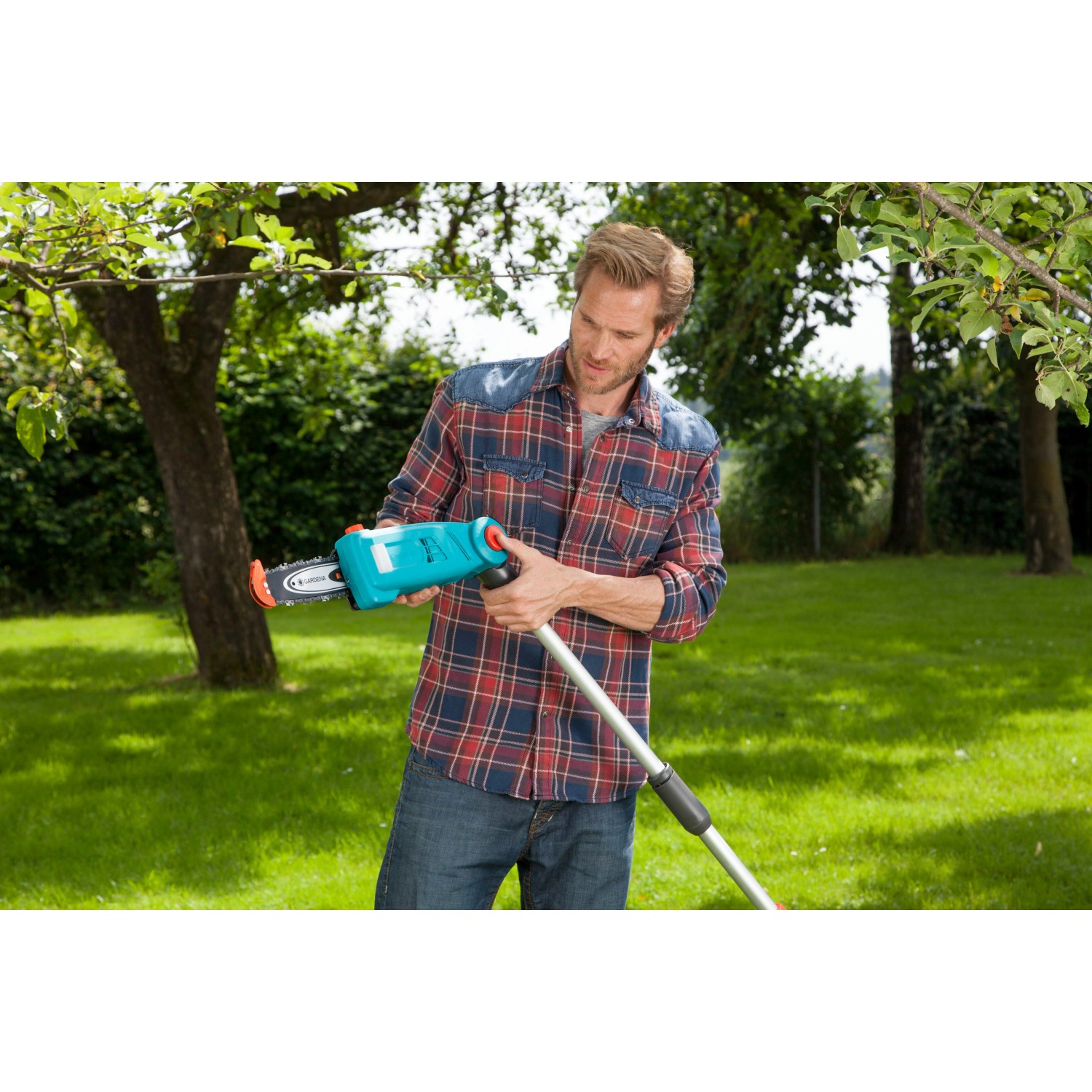 Mann benutzt Gardena Elektro-Teleskopsäge TCS 720/20 im Garten.