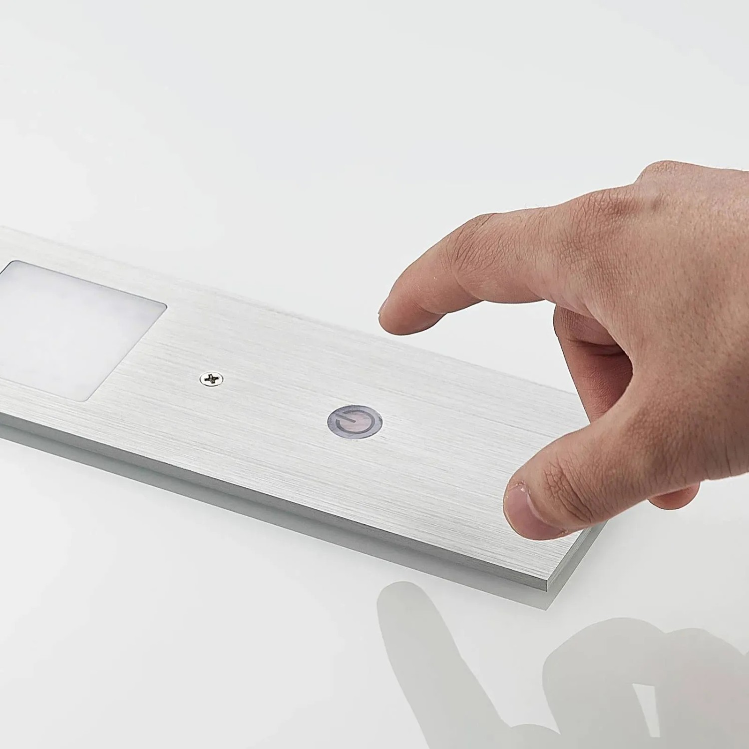 Nahaufnahme einer dimmbaren Arcchio LED Unterbauleuchte Nortra in Alu mit Touch-Funktion.