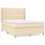 Cremefarbenes Boxspringbett 140x190 cm mit Stoffbezug und Matratze.