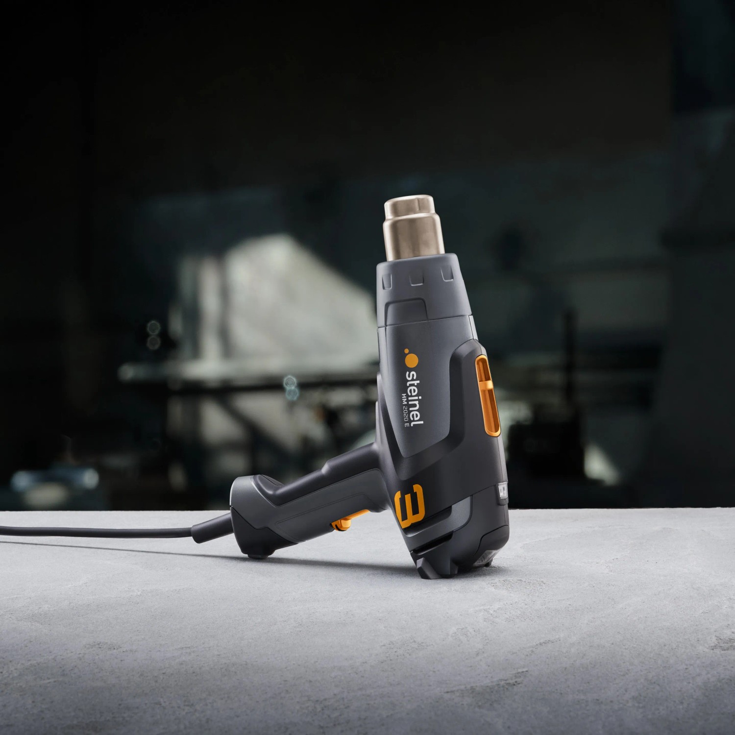 Steinel Heißluftgebläse HM 2020 E, 2000 W, graues Gehäuse mit orangefarbenen Akzenten.