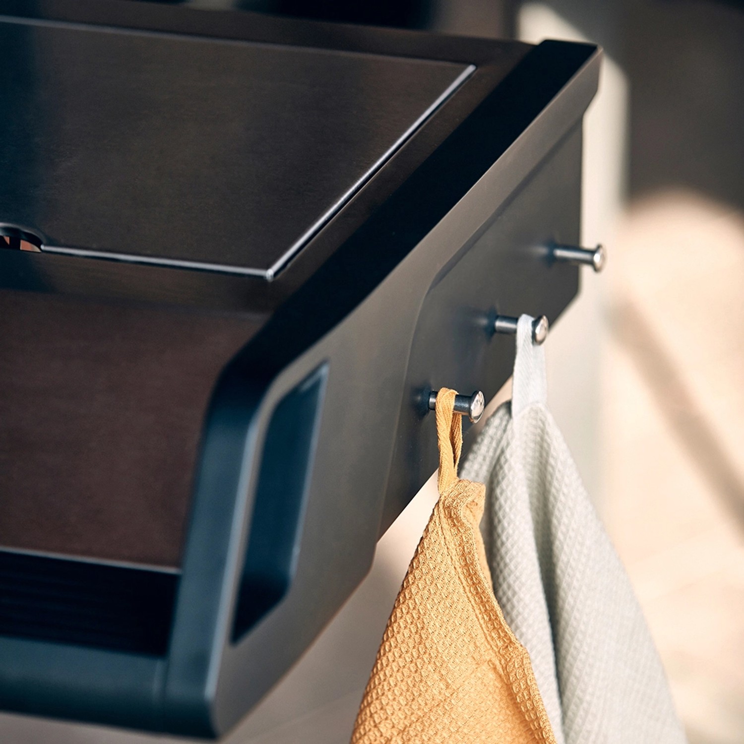 Detailaufnahme Enders Gasgrill Monroe Pro 4 SIK Turbo: Seitenkocher mit Handtüchern an Haken.