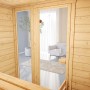 Innenansicht Weka Massivholzsauna Valida 2 mit Glastür und Liegeflächen.