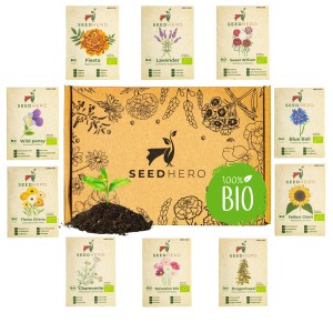 Seedhero BIO Blumensamen Set mit 10 Sorten essbaren Blüten, präsentiert in einer Box mit Erdhügel und Pflanze.