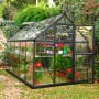 Palram Canopia Gewächshaus, 5,7 m², grau, mit Pflanzen und Fundamentrahmen im Garten.