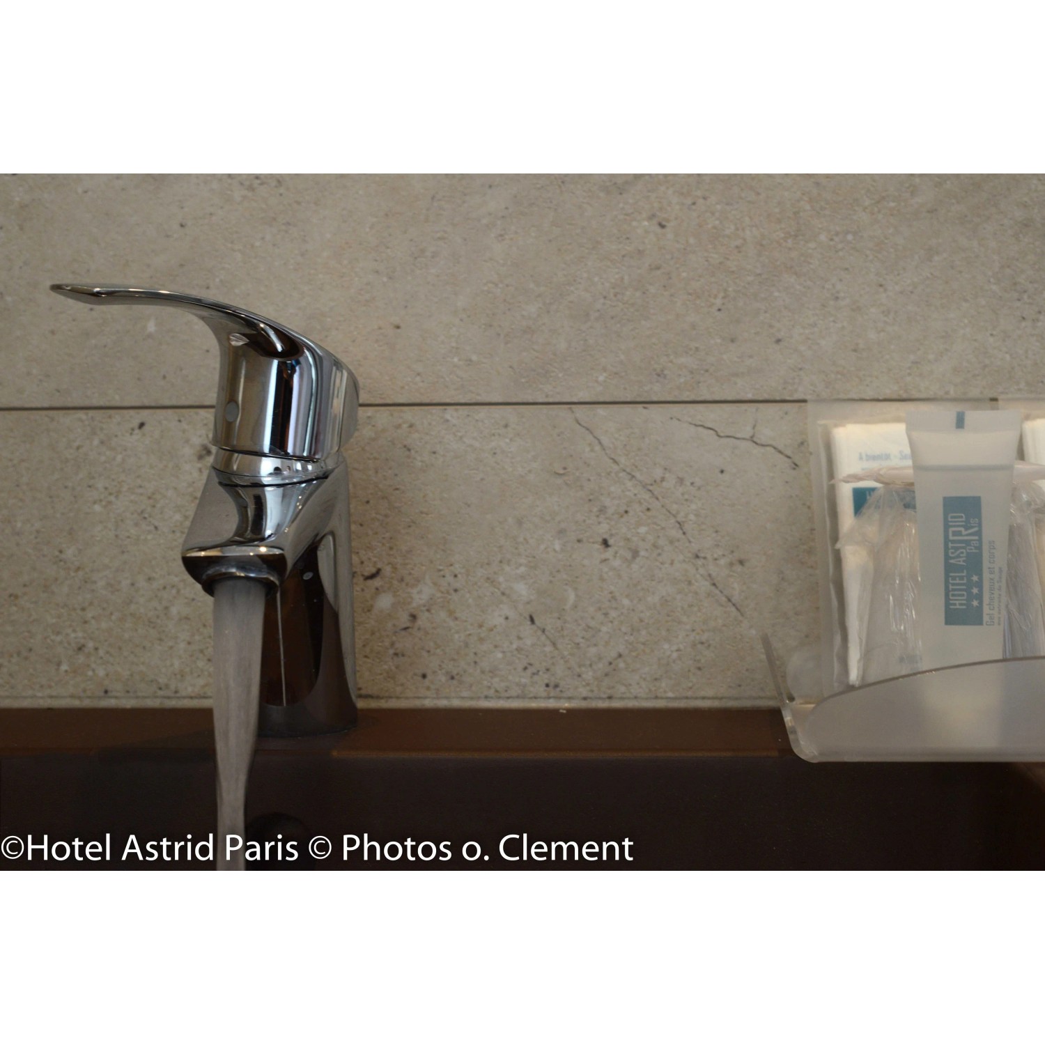 Grosfillex GX Wall+ Creme Slate Dekor-Paneele im Badezimmer mit Armatur und Wasser.