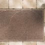 Sandfarbene Astra Türmatte Graphic Deluxe, 45x75 cm, mit modernem Kreis-Design.