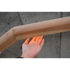 Hand unter beleuchtetem Holzhandlauf mit integrierter LED-Beleuchtung. Zeigt Anwendung für LED-Handlaufträger.