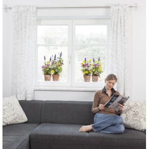 Komar Fenstersticker Springtime, 31x31 cm, mit bunten Blumenmotiven auf einem Fenster, Frau auf Sofa.