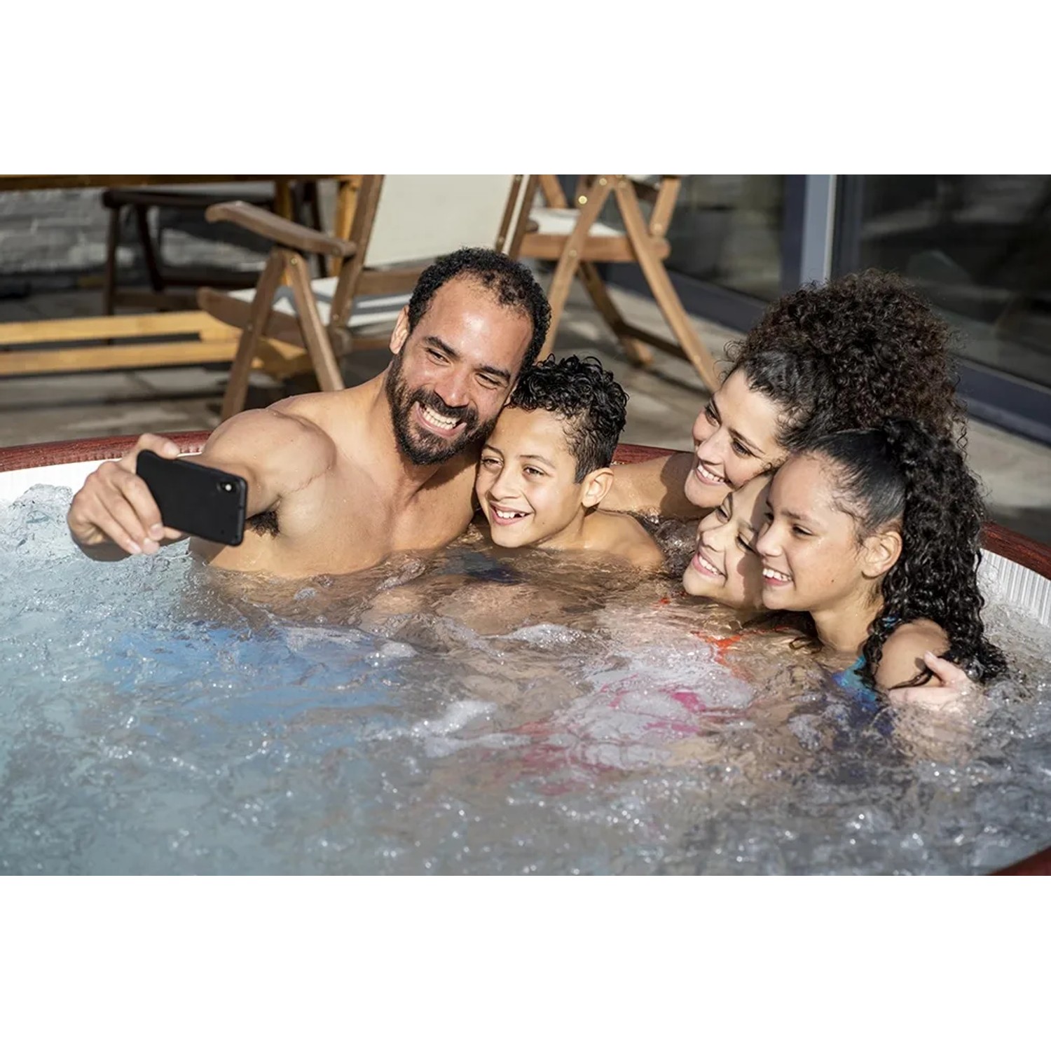 Familie im LAY-Z-SPA Helsinki AirJet Whirlpool (180 cm) mit Holzoptik beim Selfie machen.