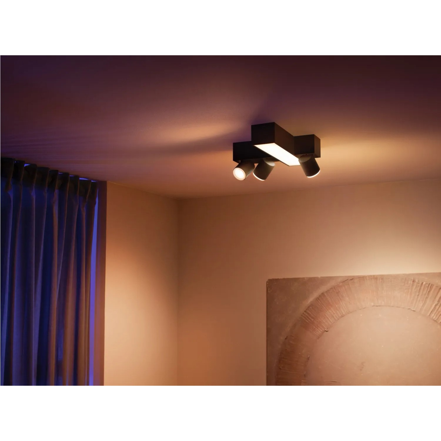 Schwarze Philips Hue Centris Cross LED-Deckenleuchte mit 3 Spots und Lightbar an der Decke.