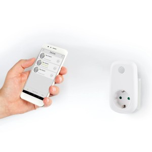 Weißer Wifi-Stecker Schuko mit App-Steuerung und Smartphone in der Hand.