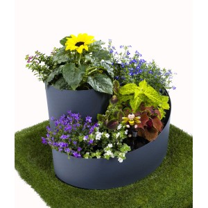 Graue Jardinion Kräuterspirale (35cm) bepflanzt mit Kräutern und Blumen auf Rasen.