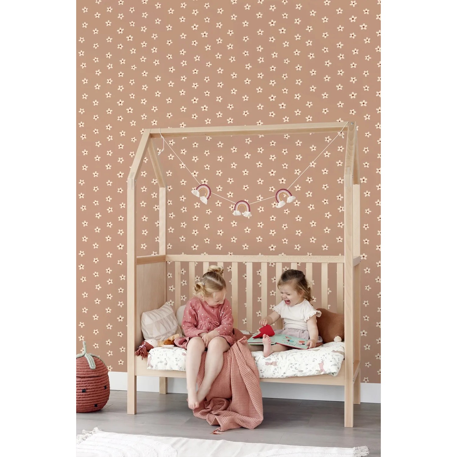 ESTAhome Vliestapete Terrakottarosa mit weißen Sternen im Kinderzimmer über einem Holzbett. Dekorative Tapete.