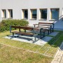 HL Drainpflaster Füllsteine in steingrau auf Rasengitter mit Sitzgruppe im Außenbereich.