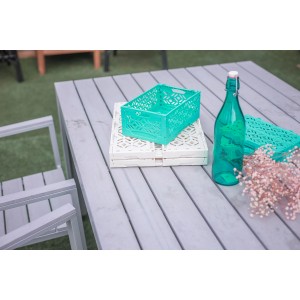 Türkis Klappbox-Mini, gestapelt auf einer weißen, auf einem Tisch im Freien.