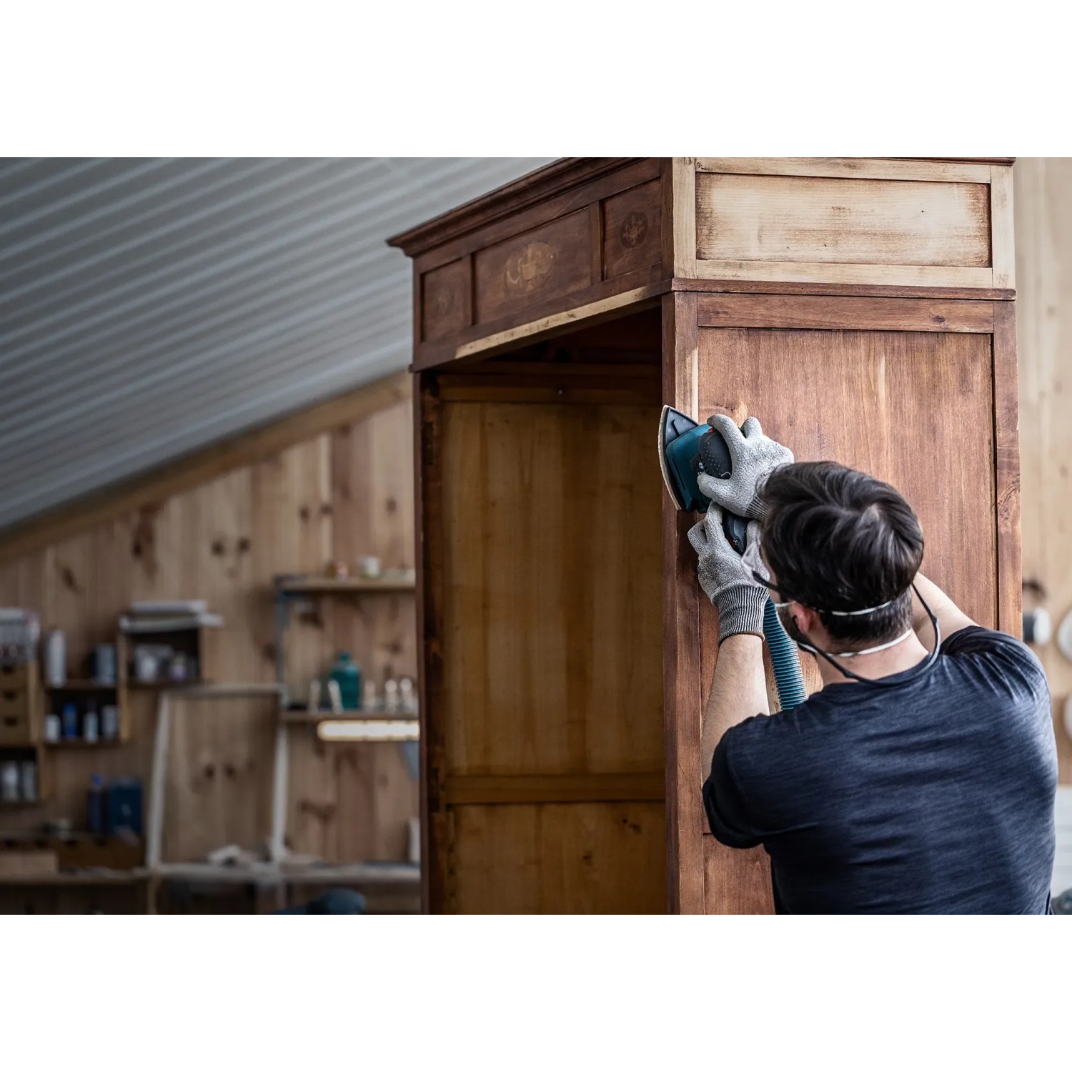 Mann schleift Holzschrank mit Bosch Expert Netzschleifblatt M480 K180 und Exzenterschleifer.