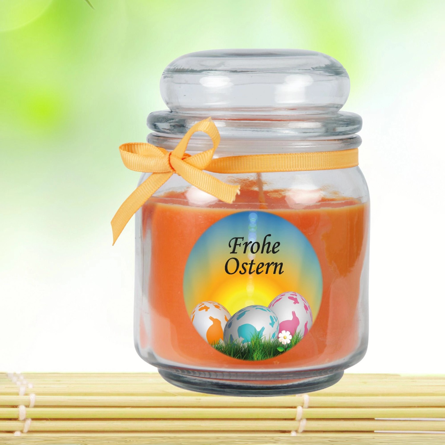Duftkerze Frohe Ostern im Glas (Ø9cm) mit Honigmelonen-Duft und Ostereier-Motiv.