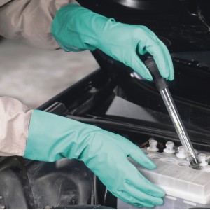 Hände mit LUX Nitril-Schutzhandschuhen Gr. 8 prüfen Autobatterie.