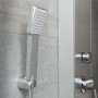 Schütte Duschpaneel Tahiti Edelstahl: Handbrause und Teilansicht des Paneels an grauer Wand.