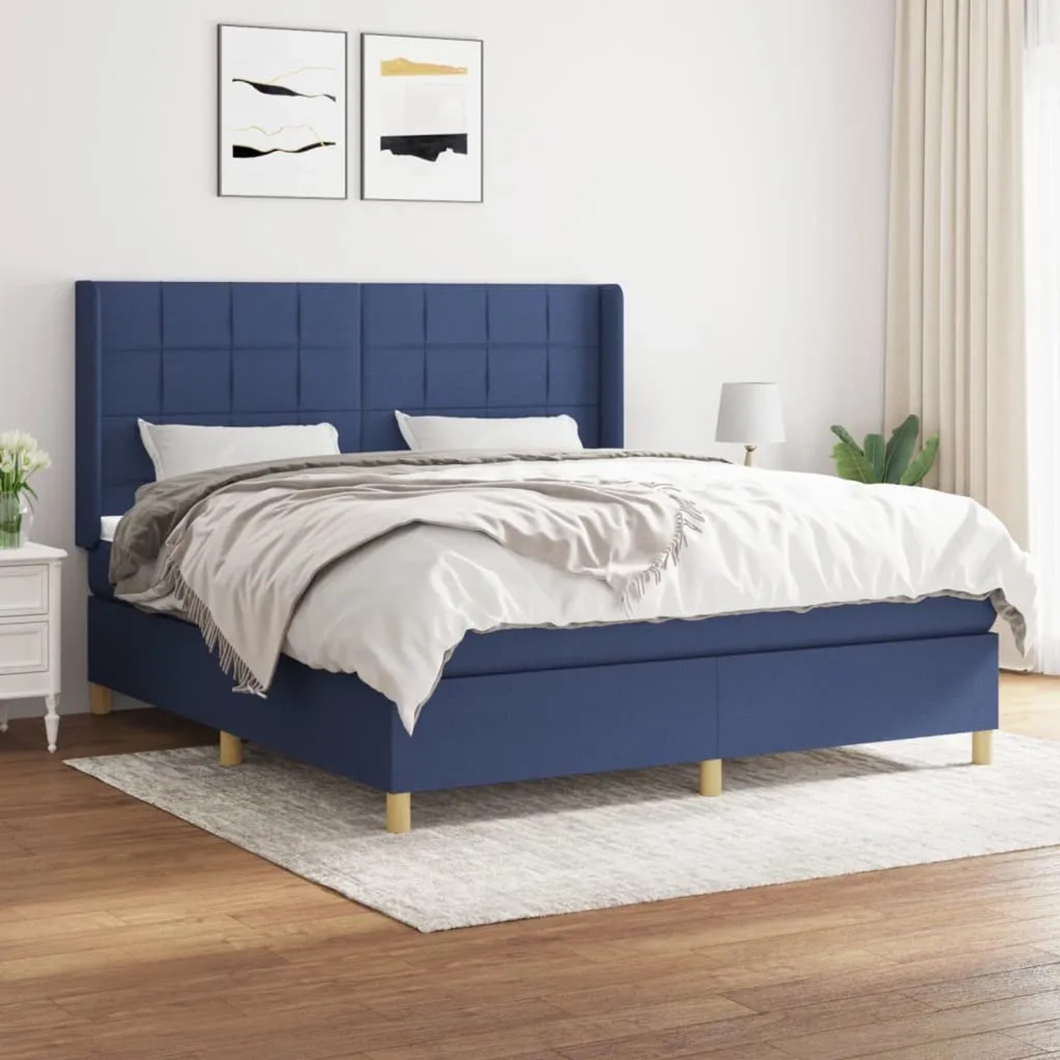 Blaues Boxspringbett (180x200 cm) mit Matratze und Kopfteil. Stoffbezug.