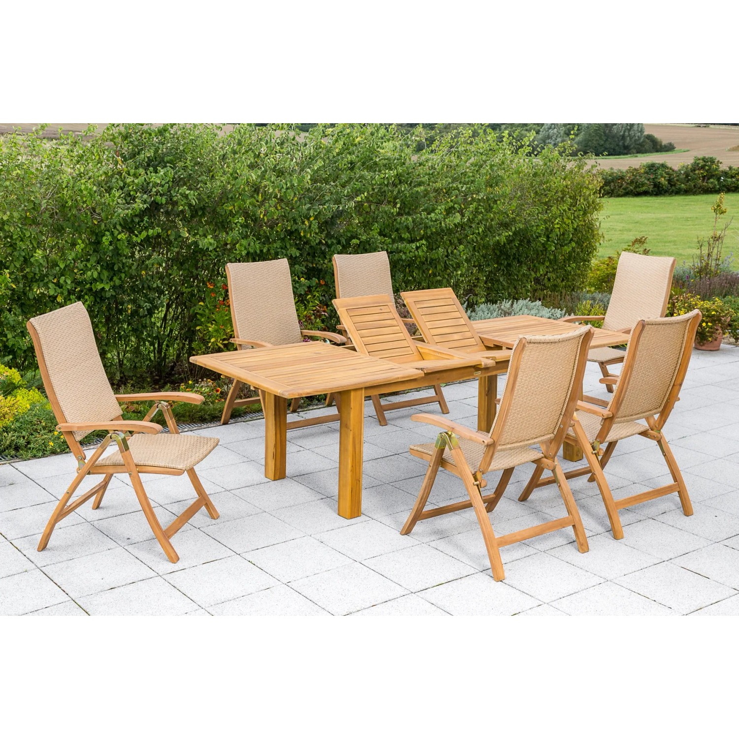 7-teiliges Gartenmöbel-Set Capri mit Doppelausziehtisch aus Akazienholz und Polyrattan-Sesseln.