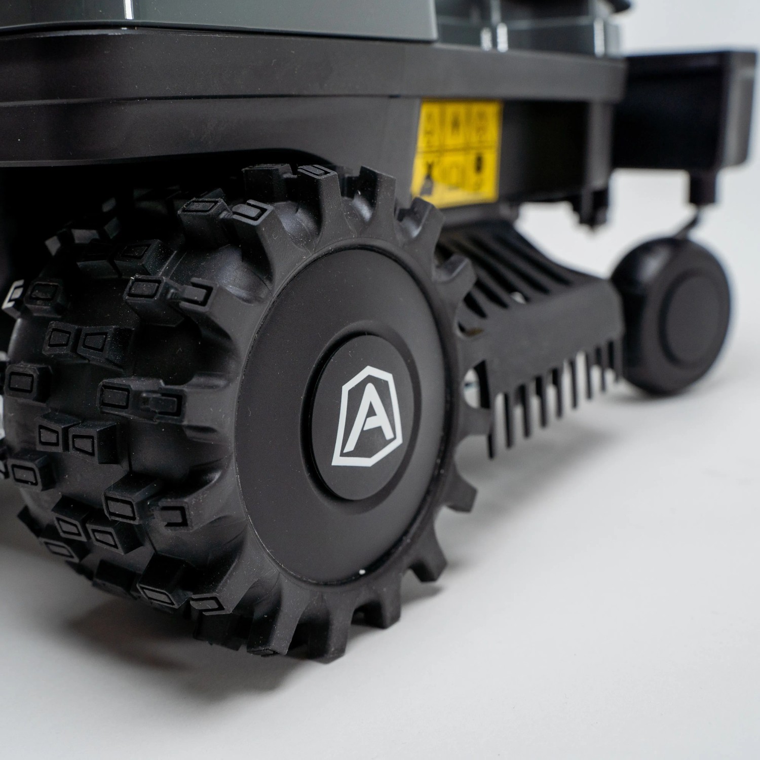 Detailaufnahme: Rad des Ambrogio Zeta R Mähroboters in Schwarz-Orange.