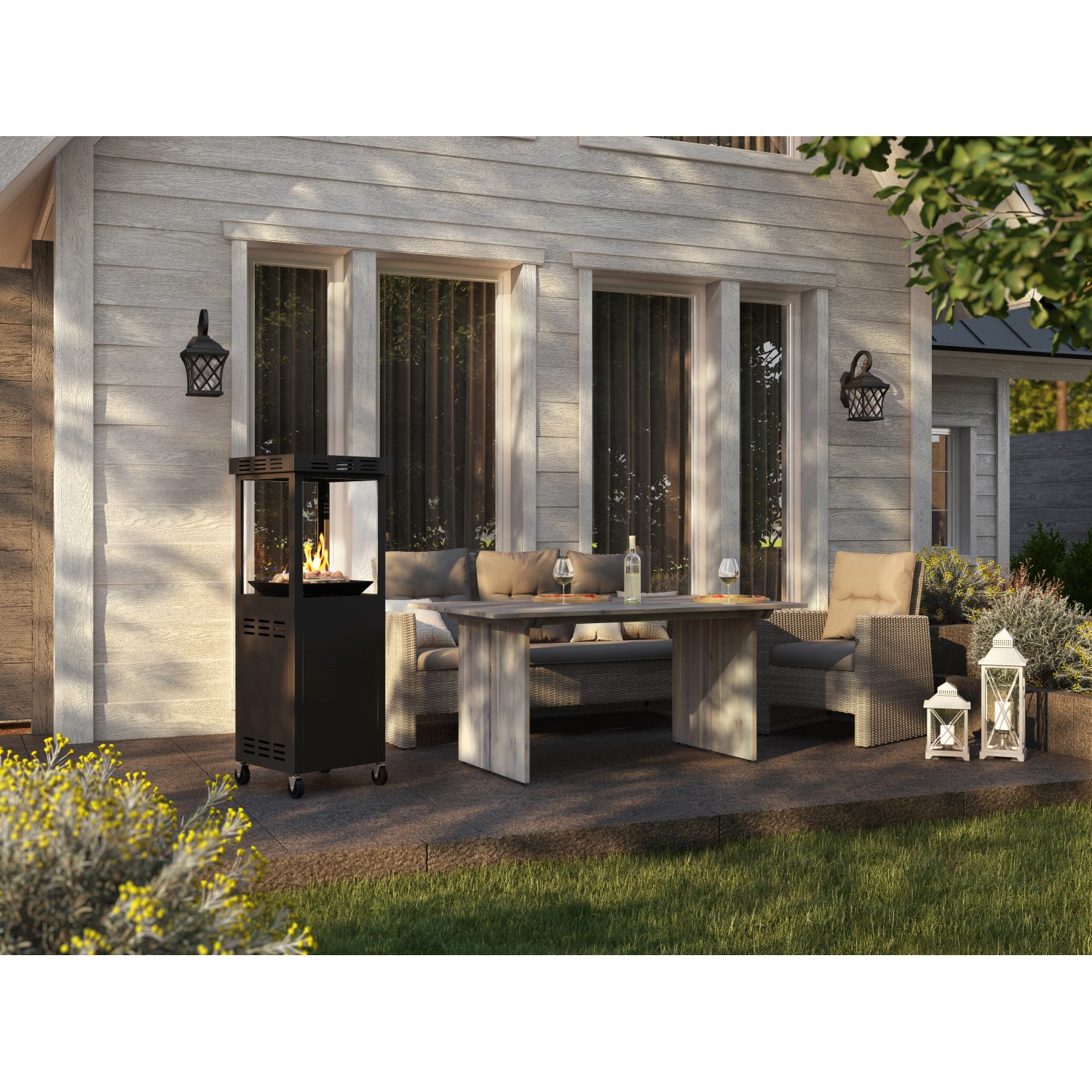 Anthrazitfarbener Gaskamin Ridera mit Panoramaglas und Lavasteinen auf Terrasse mit Sitzgruppe.