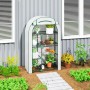 Weißes Furnicato Mini-Gewächshaus, 4-stufig, mit Pflanzen auf Drahtregalen im Garten.