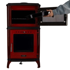 Roter Kaminofen Ferrox 55 Back mit Backrohr. Hand schiebt Backblech in den Ofen. Gussofen 7 kW emailliert.