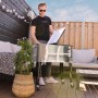 Axi Kühlwagen Retro Edelstahl 76 l mit Mann im Garten, ideal für Partys und BBQs.