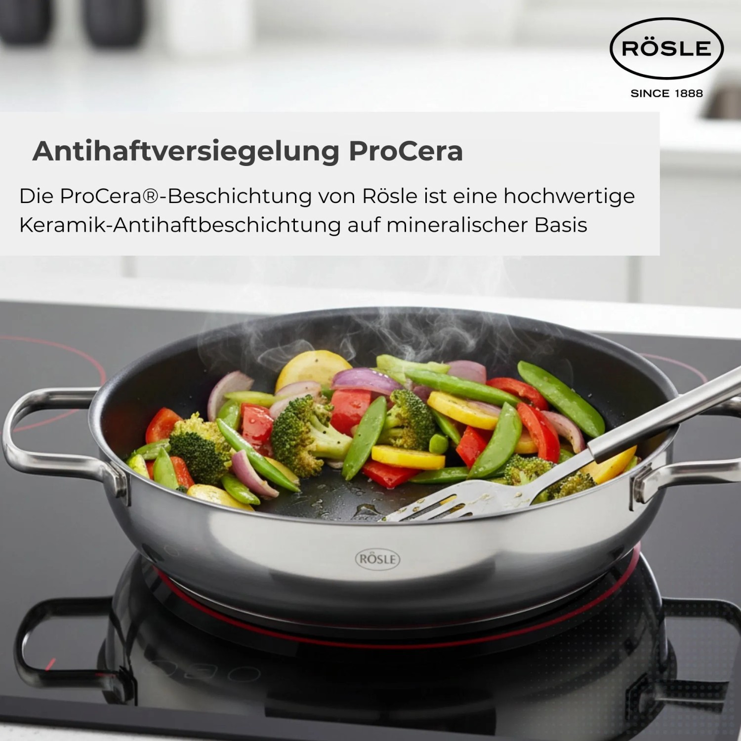 RÖSLE Elegance Servierpfanne Ø28 cm mit ProCera Keramikbeschichtung, gefüllt mit buntem Gemüse beim Braten auf Induktion.