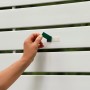 Anwendung Tesa Powerbond Montageband Outdoor (1,5m x 19mm) auf weißem Zaun.