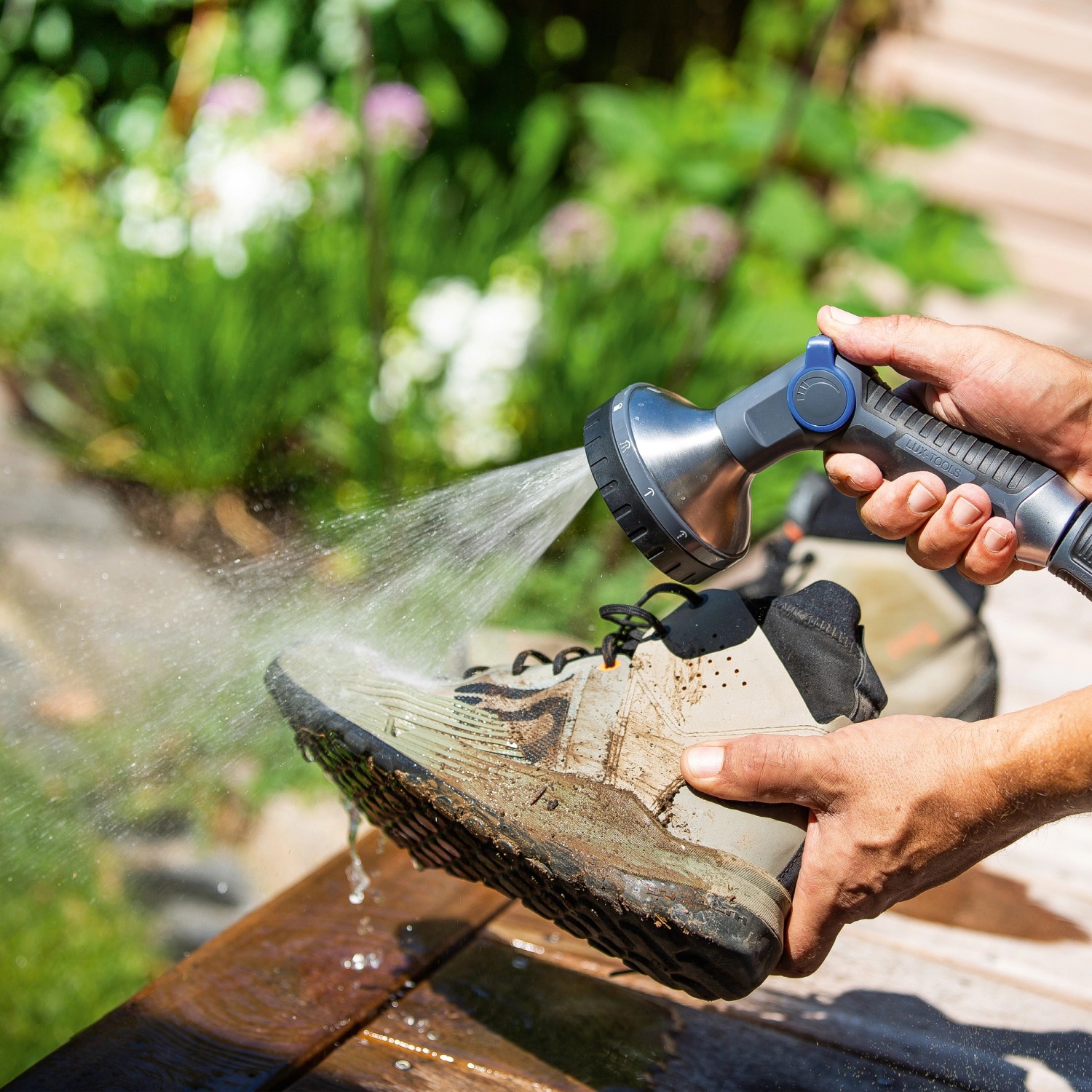 LUX Multifunktionsbrause reinigt schmutzige Schuhe. Gartenbrause mit 10 Strahlvarianten im Einsatz.