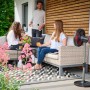 Einhell Akku-Ventilator GE-CF 18/320 P Li-Solo im Einsatz auf einer Terrasse mit entspannten Personen.