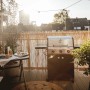 Enders Gasgrill Chicago Next 3 mit 3 Brennern auf Balkon mit Tisch und Deko.