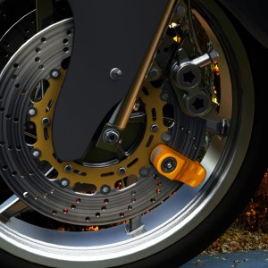 Basi Bremsscheibenschloss in Gelb am Motorrad mit Erinnerungskabel und 2 Schlüsseln.