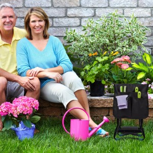 Schwarze Relaxdays Kniebank/Gartenhocker aus Stahl mit Werkzeugtaschen im Garten. Klappbar für bequeme Gartenarbeit.