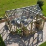 Palmako Gewächshaus Emilia 19 Grau, 19,1 m², Holzrahmen, Glas, auf Terrasse im Garten.