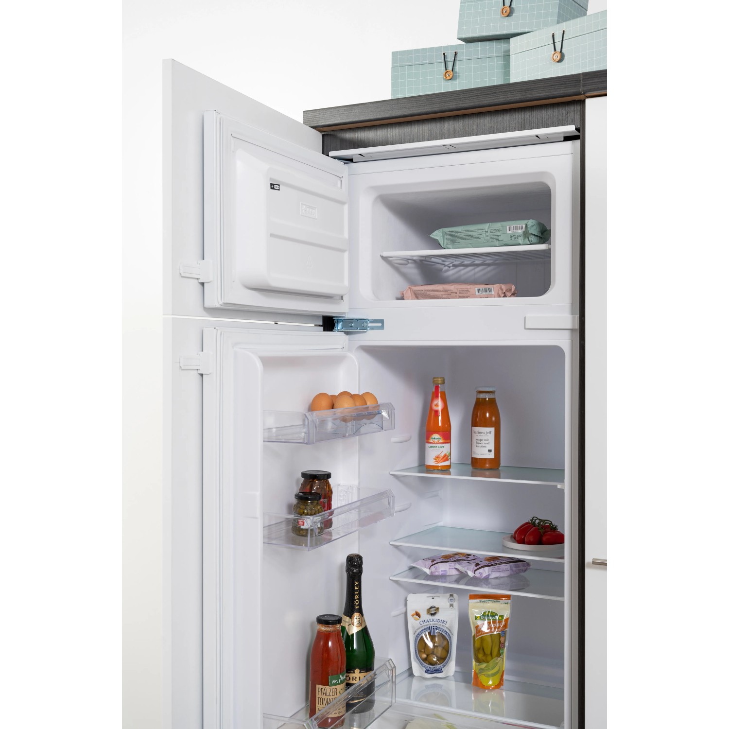Offener Kühlschrank der Respekta Premium Winkelküche, gefüllt mit Lebensmitteln.