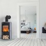 Fireplace Zaria Kaminofen, 6 kW, Speckstein, schwarz, mit Holzscheiten im Brennraum.