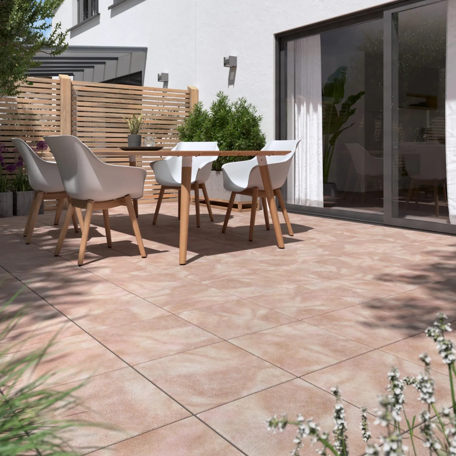 Verlegte Diephaus Terrassenplatten Nano Tec Ocker-Gelb-Rose auf einer Terrasse mit Gartenmöbeln.