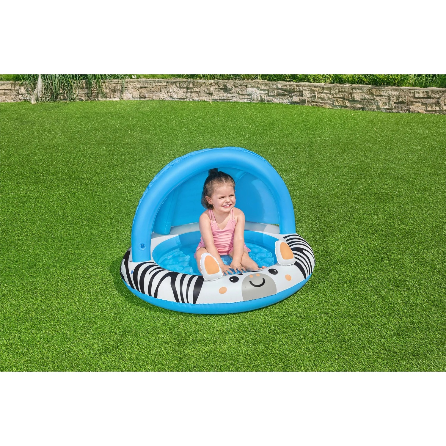 Bestway Planschbecken Safari Sun mit Zebra-Design und Sonnenschutzdach, genutzt von einem Kind.
