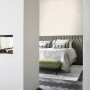 Beige Blätter Tapete von Origin Wallcoverings im Schlafzimmer mit Kamin und dunklem Holzboden.