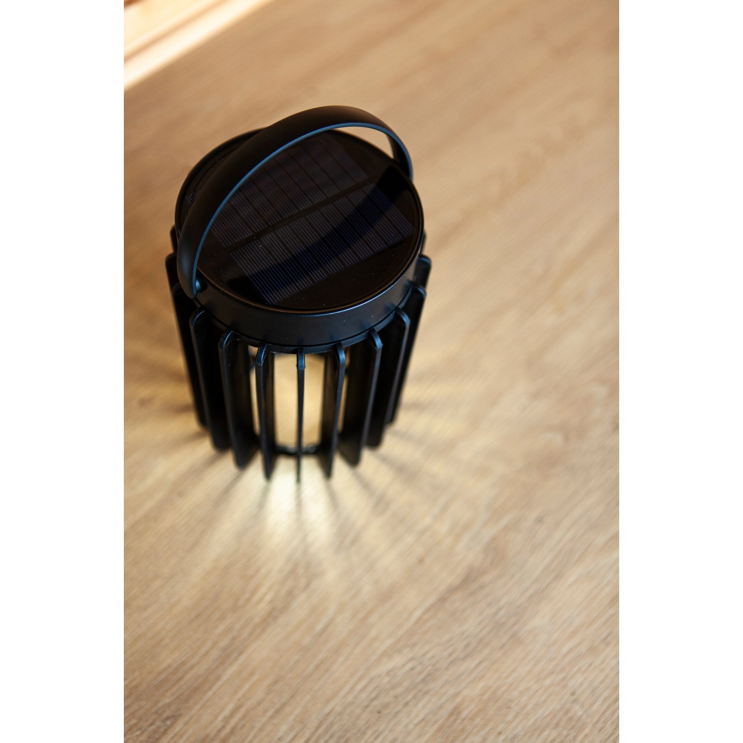 Schwarze Lutec LED Solar Tischleuchte Kozy mit Gitterstruktur und Tragegriff.