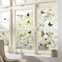 Fenster mit Komar Fenstersticker Cheerful mit bunten Schmetterlingen und Blütenzweigen.