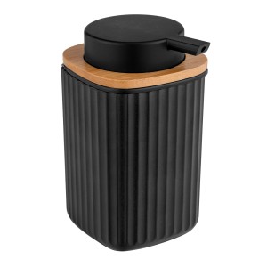 Schwarzer WENKO Seifenspender Rotello mit Rillenstruktur und Bambusdeckel.