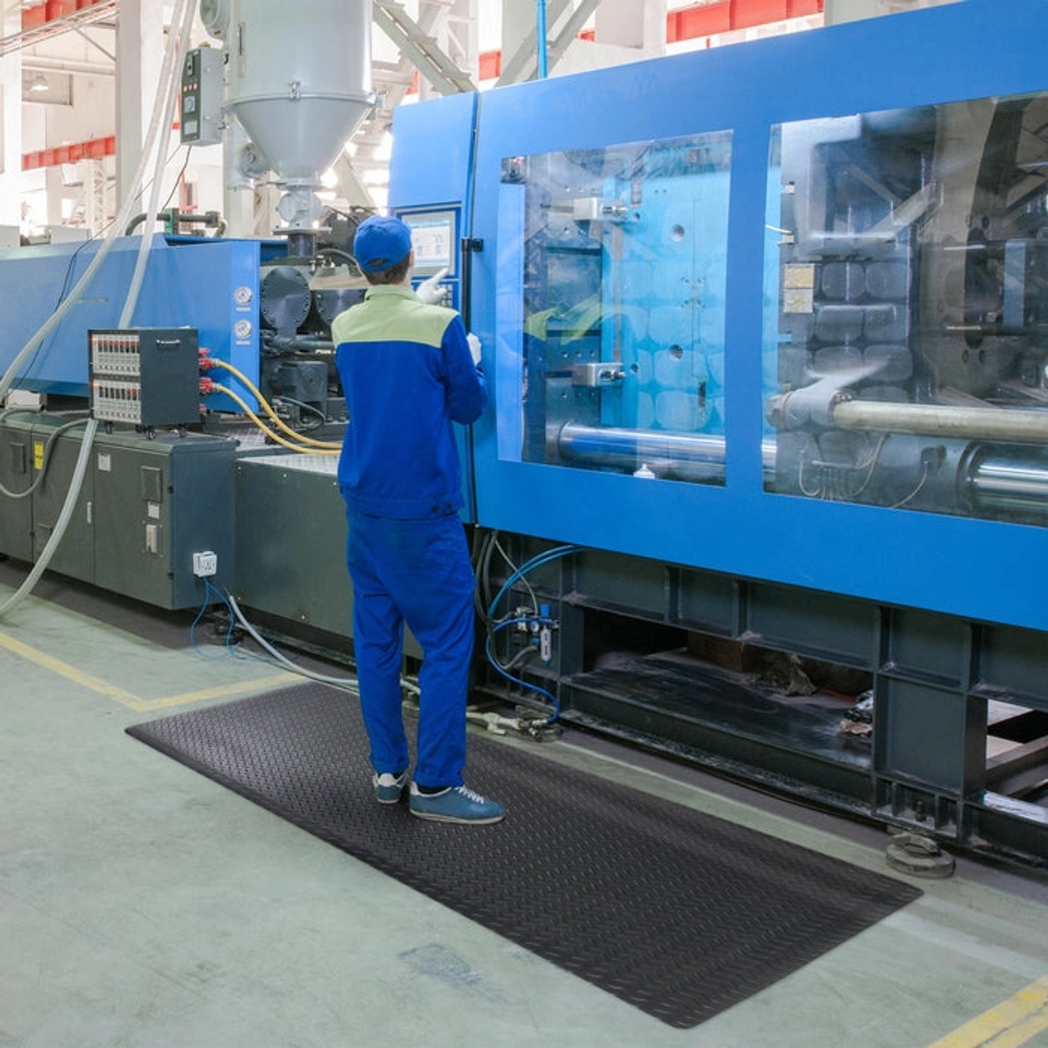 Schwarze KARAT Anti-Ermüdungsmatte Dyna-Protect Diamond 90x900 cm am Arbeitsplatz.