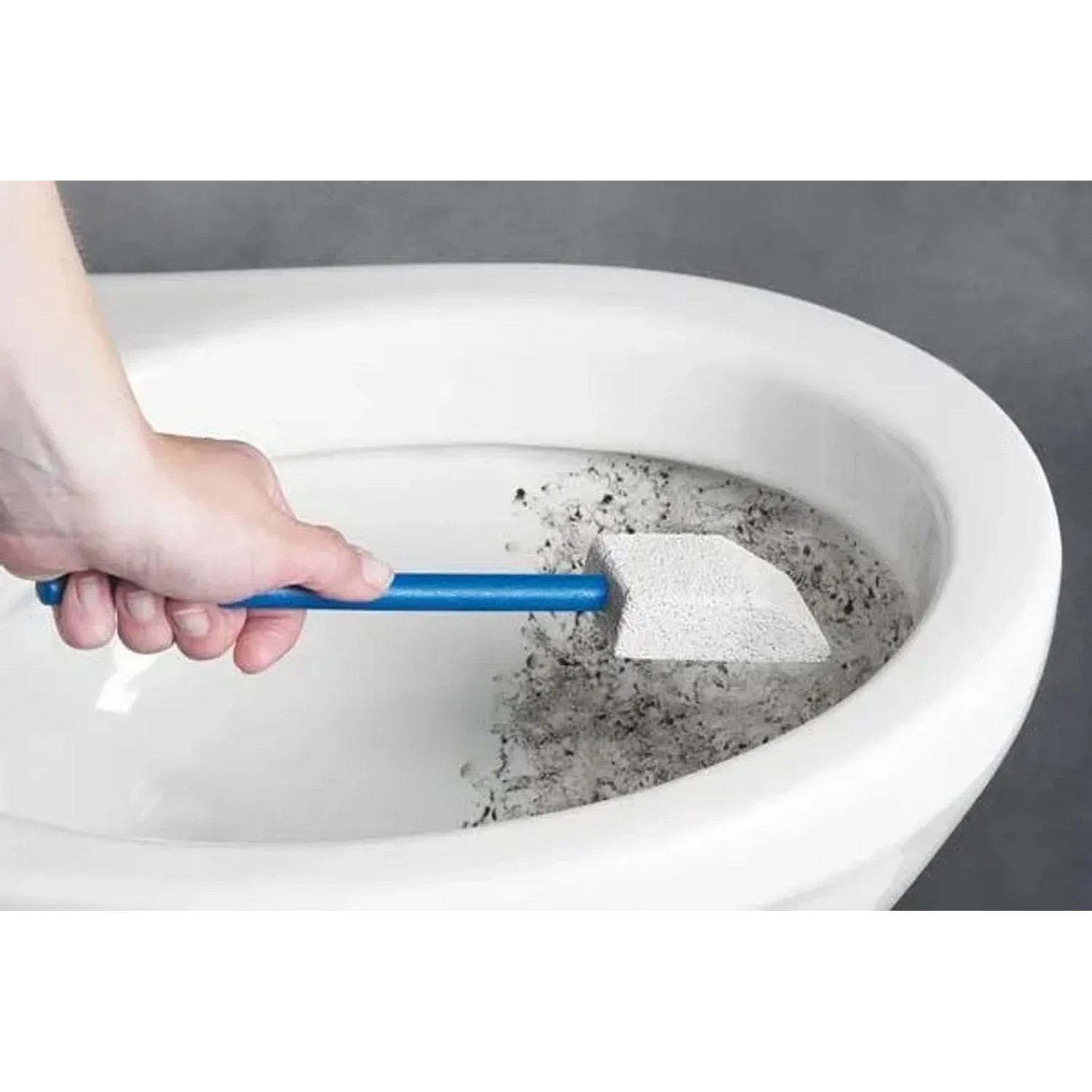Hand reinigt Toilette mit Westfalia Bimsstein. Langer blauer Stiel, abgeschrägter Stein entfernt Kalkablagerungen.