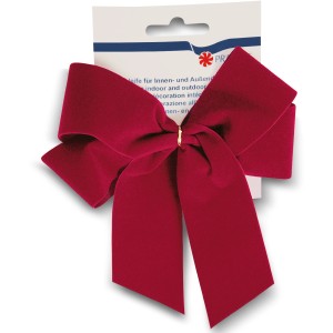 Handgebundene, rote Samtschleife als Weihnachtsdekoration.