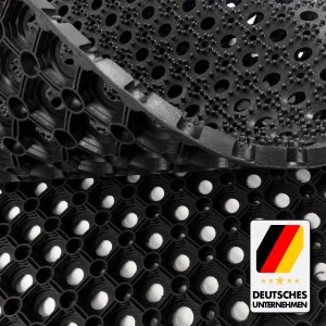 Schwarze KARAT Ringgummimatte Octo Door, recyclebar, mit Wabenstruktur und Löchern für Drainage.